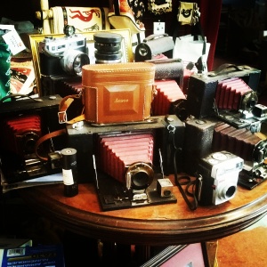 A table of older cameras on display